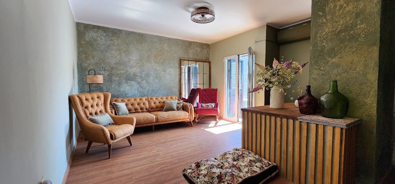 Living room in a townhouse in Petrovac, Montenegro: stylish interior with decorative plaster and soft furnishings.