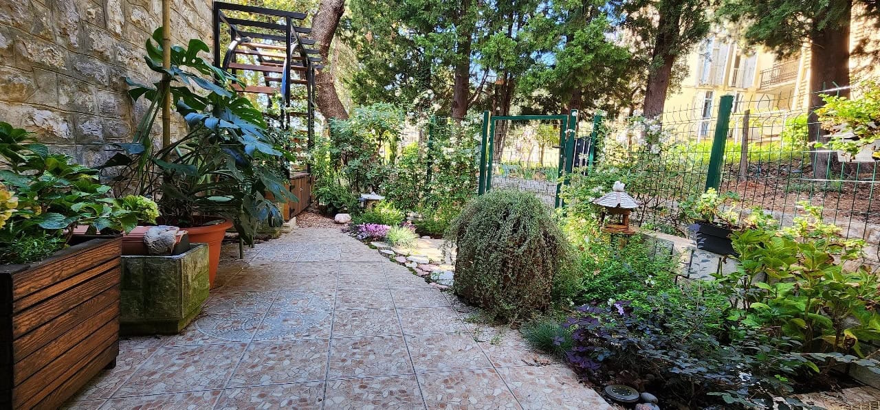 Cozy green courtyard with a terrace and garden by a townhouse in Petrovac, Budva, Montenegro.