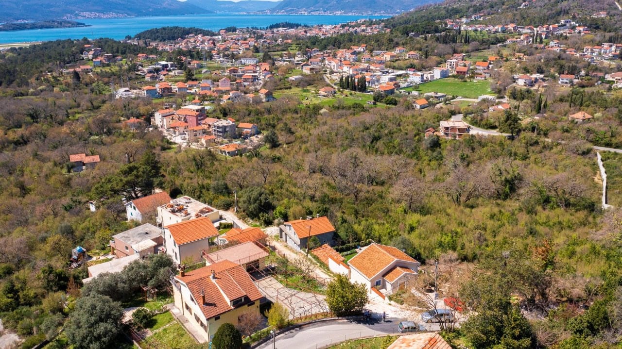 Aerial view of a land plot in Kavac, Montenegro, with panoramic views of the mountains and Tivat Bay.