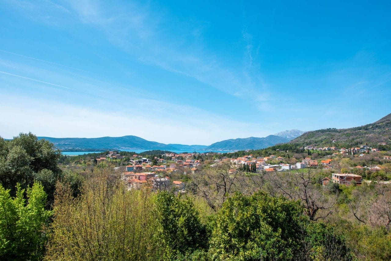 Panoramic view of the mountains, the sea, and the village of Kavac in Montenegro from a plot of land for house construction.