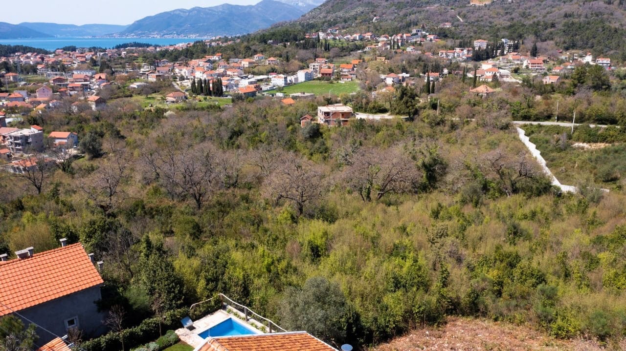 Land plot in Kavac, Montenegro: panoramic view of the mountains, sea, and private pool with terrace.