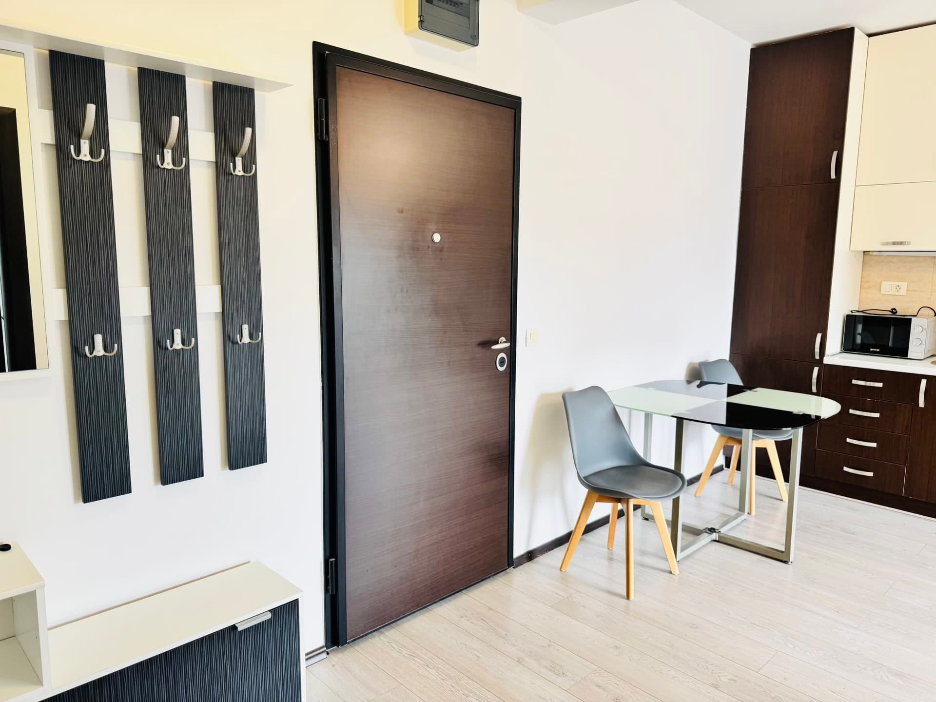 Interior of the kitchen-hallway in an apartment in Budva, Montenegro: dining area, modern furniture, and the front door.