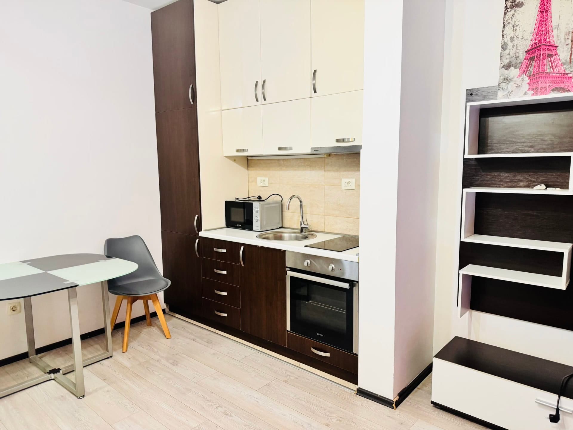Modern kitchen in an apartment in Budva, Montenegro: built-in appliances, dining area, and stylish interior.