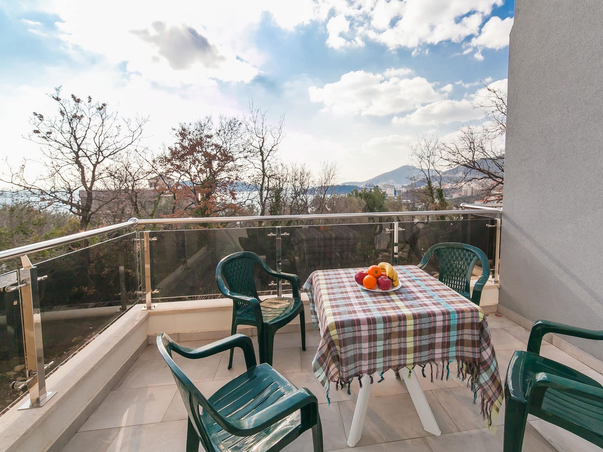 Balcony with plastic furniture and a view of the sea and mountains in an apartment, Becici, Montenegro.