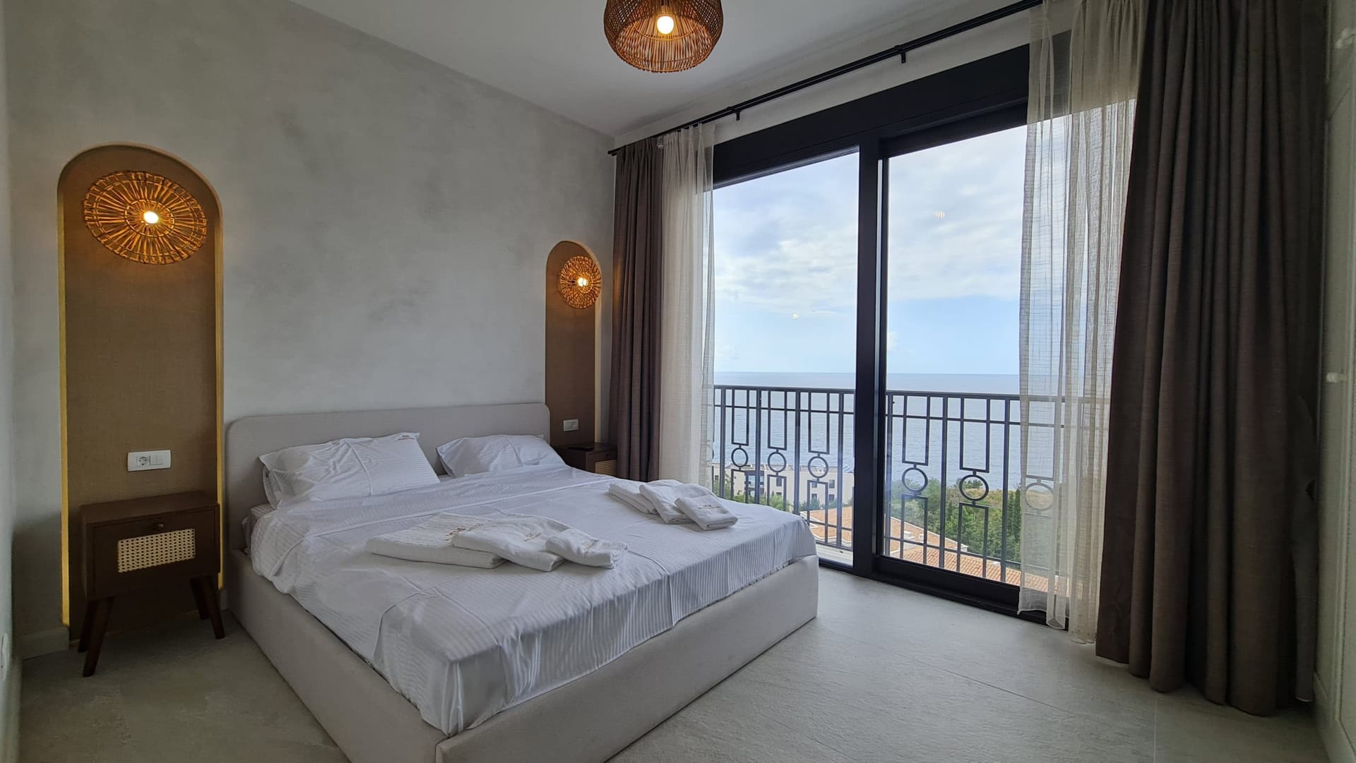 Bedroom with a double bed and panoramic sea view in Villa Skočidjevojka, Budva, Montenegro.