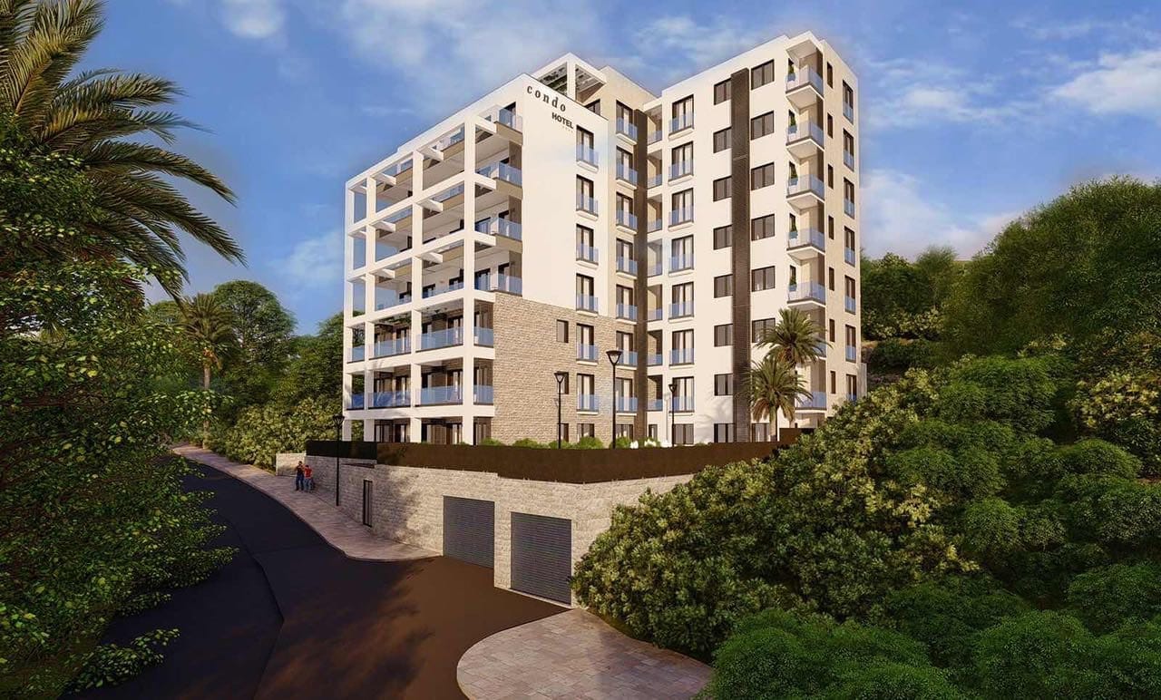 Современный жилой комплекс Condo Hotel в Бечичи, Черногория: фасад здания с панорамными балконами и зеленая территория.