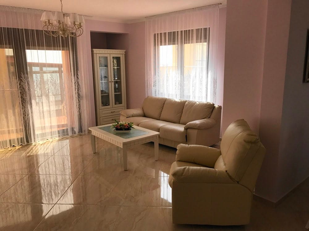 Helles Wohnzimmer mit Ledermöbeln und Panoramafenstern in einer Wohnung, Dobri Vody, Montenegro.