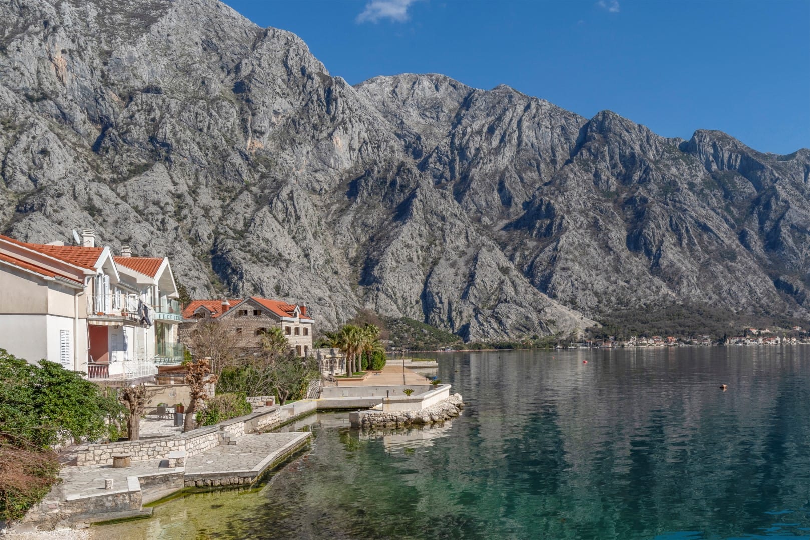 Residential complex in Orahovac, Montenegro: seaside homes with a private pier against the backdrop of the mountains of the Bay of Kotor.