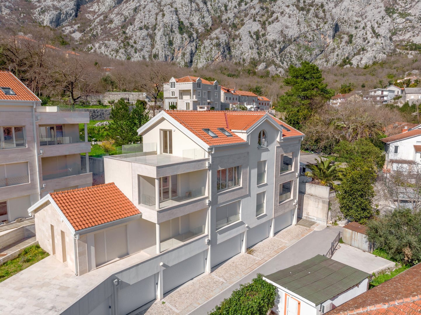 Modern residential complex with terraces and garages in Orahovac, Bay of Kotor, Montenegro, exterior view.