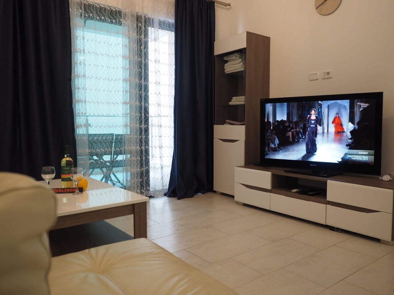 Dnevna soba u stanu u Pržnu, Crna Gora: savremeni nameštaj, TV zona, izlaz na terasu i svetao enterijer.
