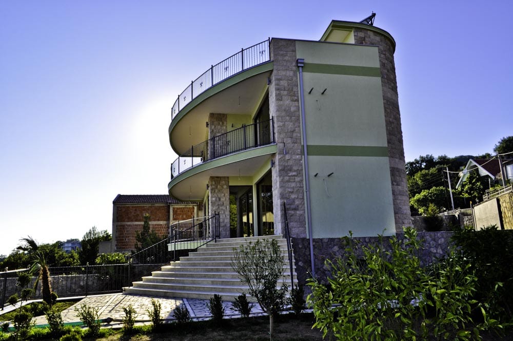 Modern villa with stone cladding and panoramic balconies in Šušanj, Montenegro: view of the facade and surrounding grounds