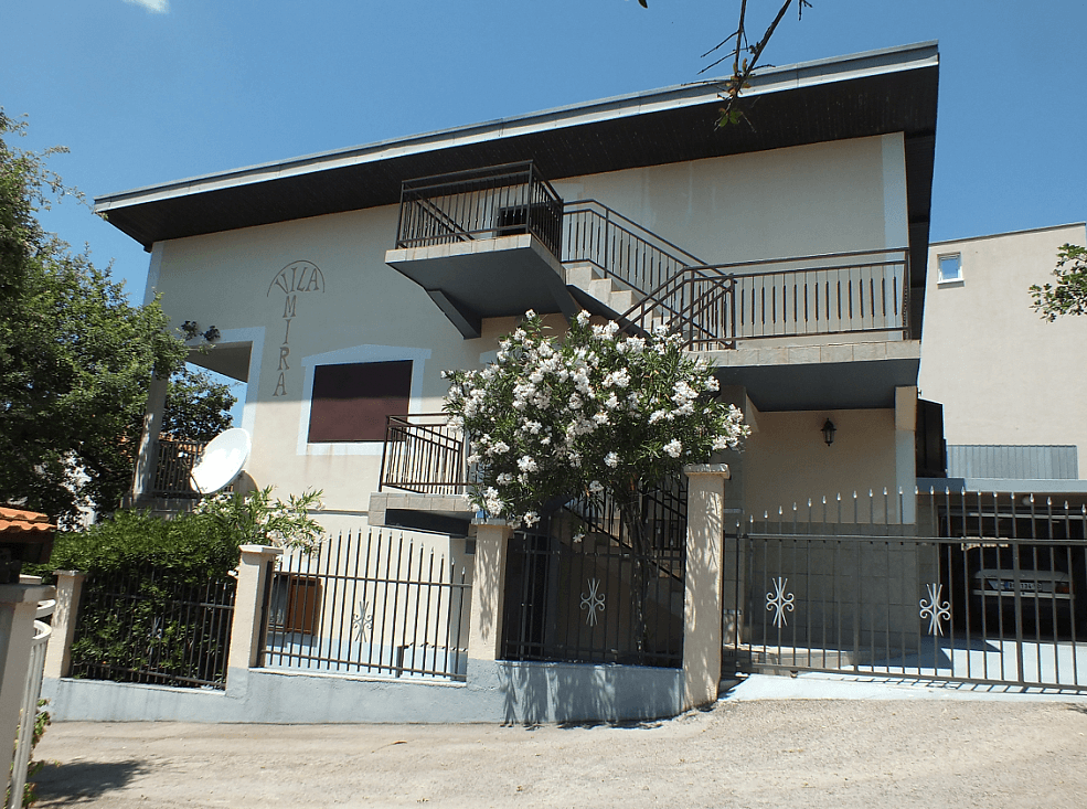 Two-story Mira villa with an external staircase and fenced grounds in Bar, Montenegro.
