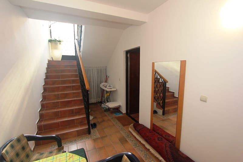 Predsoblje sa stepeništem obloženim pločicama i velikim ogledalom u stanu u Pržnu, Crna Gora.