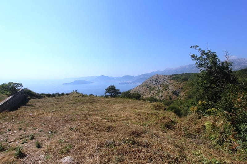 Land for sale in Kuljace, Budva Riviera, Montenegro, with panoramic sea and mountain views.