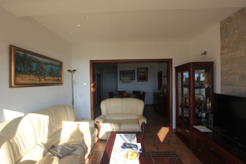 Cozy living room with leather sofas and stone finishes in a house for sale, Shushan, Montenegro.