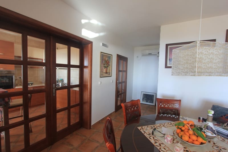 Living room with dining area and wooden doors in a house in Shushan, Montenegro. Interior with classic furniture.
