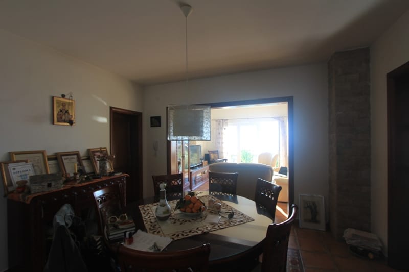 Living room with dining area in a house in Shushan, Montenegro: wooden table, stone finishes, and access to the terrace.
