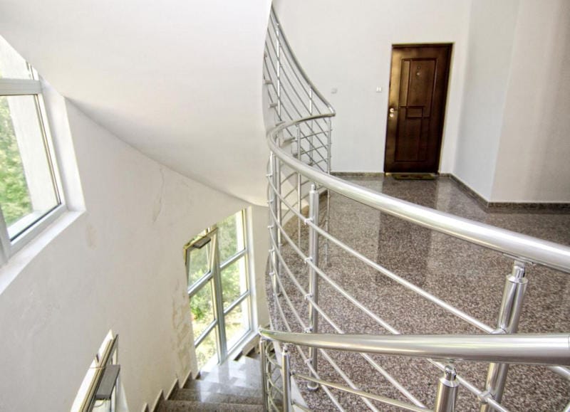 Spiralno stepenište sa metalnom ogradom i granitnim podom u stanu, Bečići, Crna Gora.