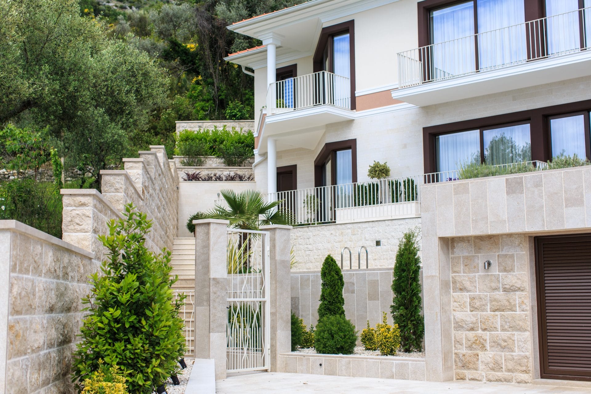 Modern villa in Tivat, Montenegro: natural stone facade, terraces, landscaping, and private grounds.