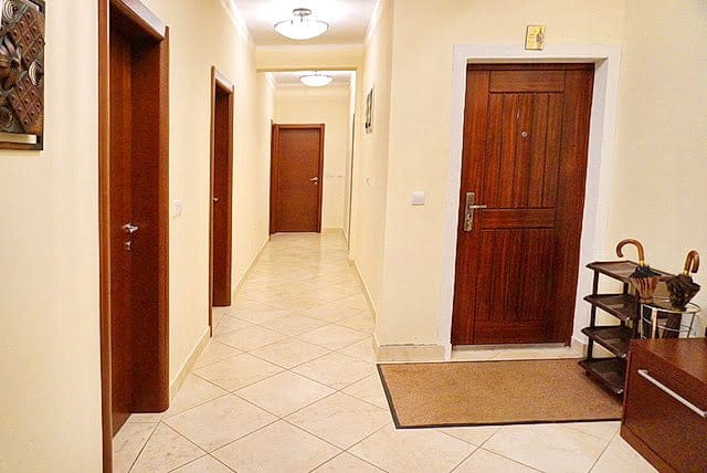 Bright hallway in an apartment, Stoliv, Montenegro: wooden interior doors, tiled floor, and entrance area.