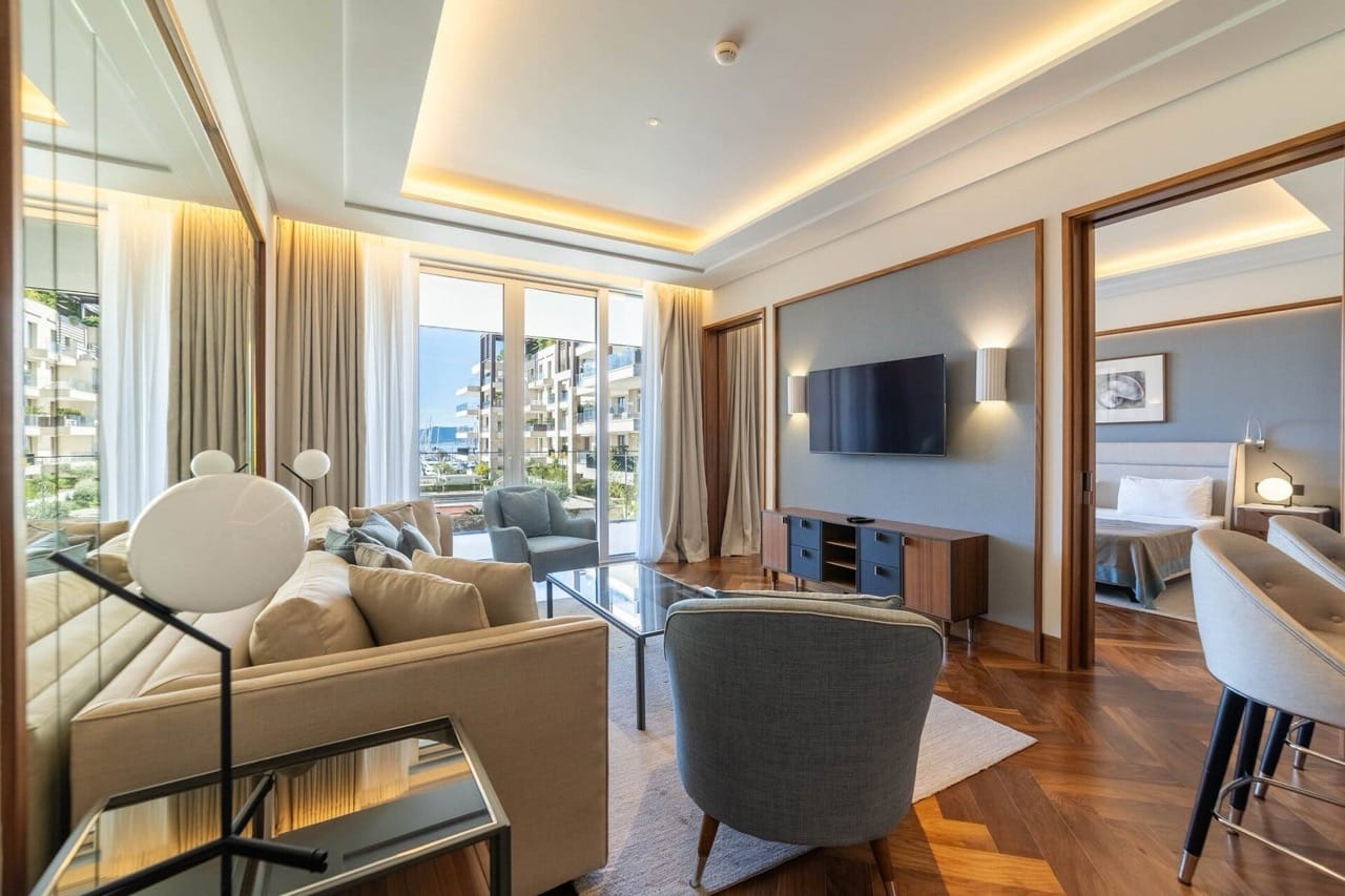 Savremena dnevna soba u apartmanima Porto Montenegro, Tivat, Crna Gora: stilni nameštaj, parket i pogled na marinu.