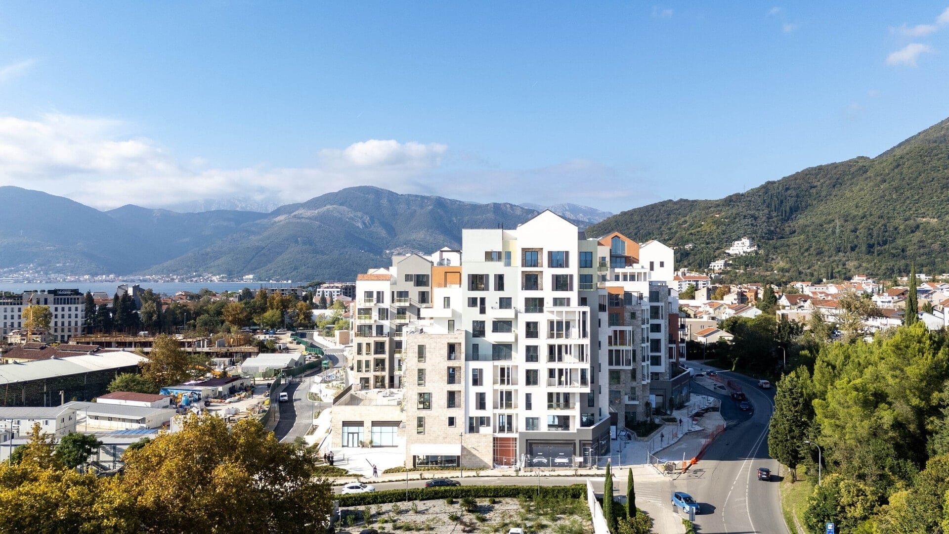 Savremeni stambeni kompleks u Porto Montenegru, Tivat, Crna Gora: pogled na arhitekturu i planine iz ptičje perspektive.