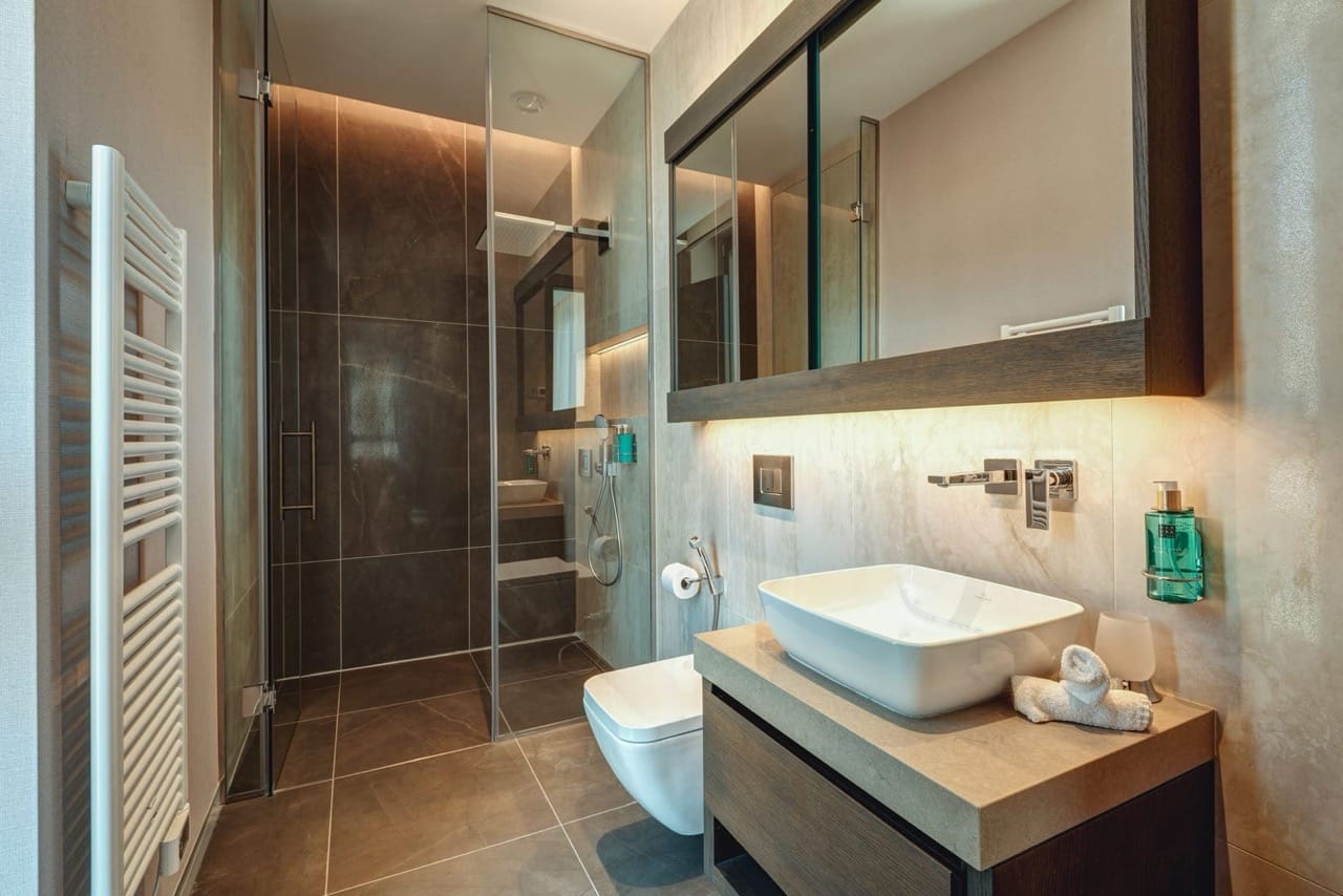 Modern bathroom in an apartment in Portonovi, Kumbor, Montenegro: shower cabin, countertop sink, and lighting.