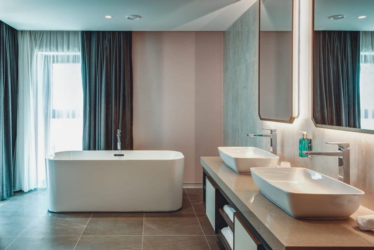 Modern bathroom with a freestanding bathtub and double vanity in Portonovi apartments, Kumbor, Montenegro