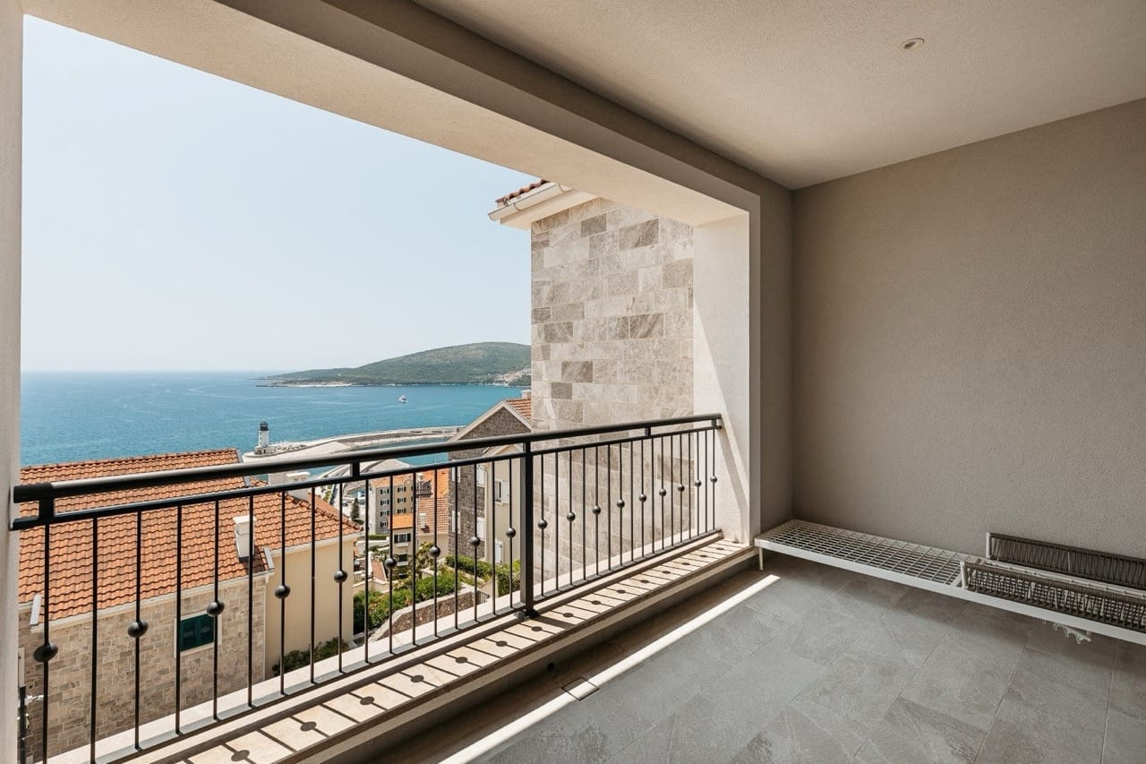 Balcony with panoramic views of the sea and harbor in Luštica Bay, Radovići, Montenegro. Modern finishes and tile.