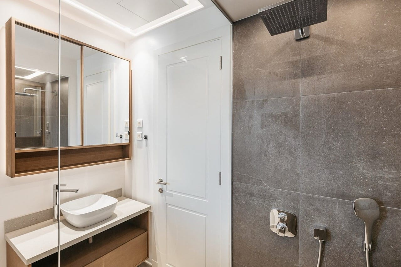 Modern bathroom with a tropical shower in the Lustica Bay apartments, Radovici, Montenegro.