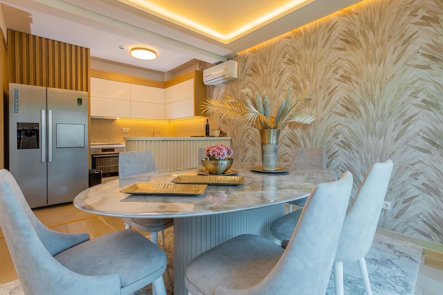 Modern kitchen-dining room with a marble table in a penthouse, Pržno, Montenegro: stylish interior and designer finishes.