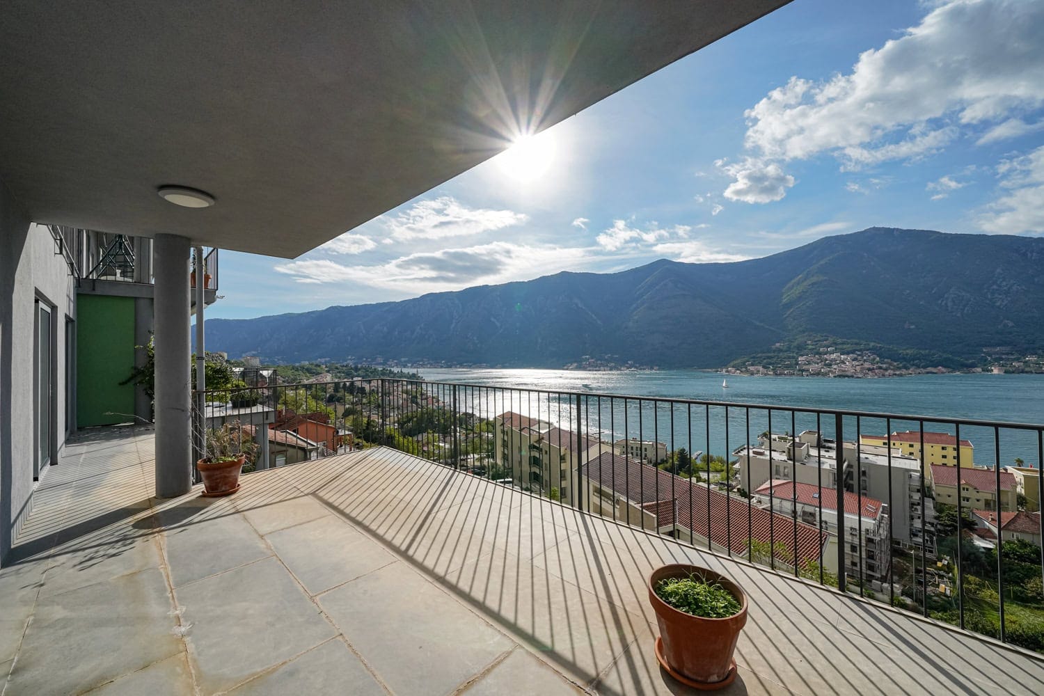 Spacious apartment terrace in Dobrota, Montenegro, with panoramic views of the Bay of Kotor and the mountains.