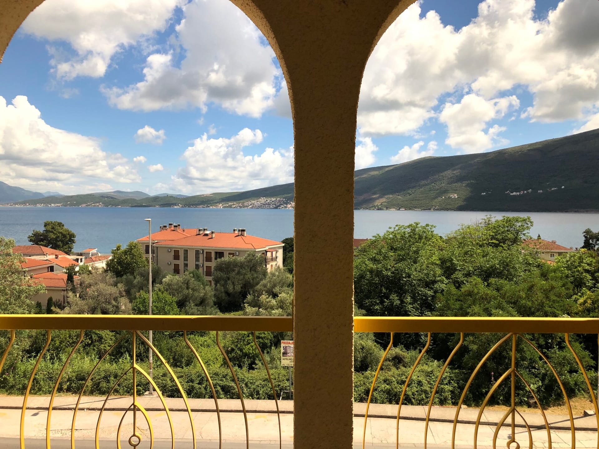 View from the balcony of the sea and mountains in Baošići, Montenegro: a panoramic landscape from the terrace of a Mediterranean-style apartment.