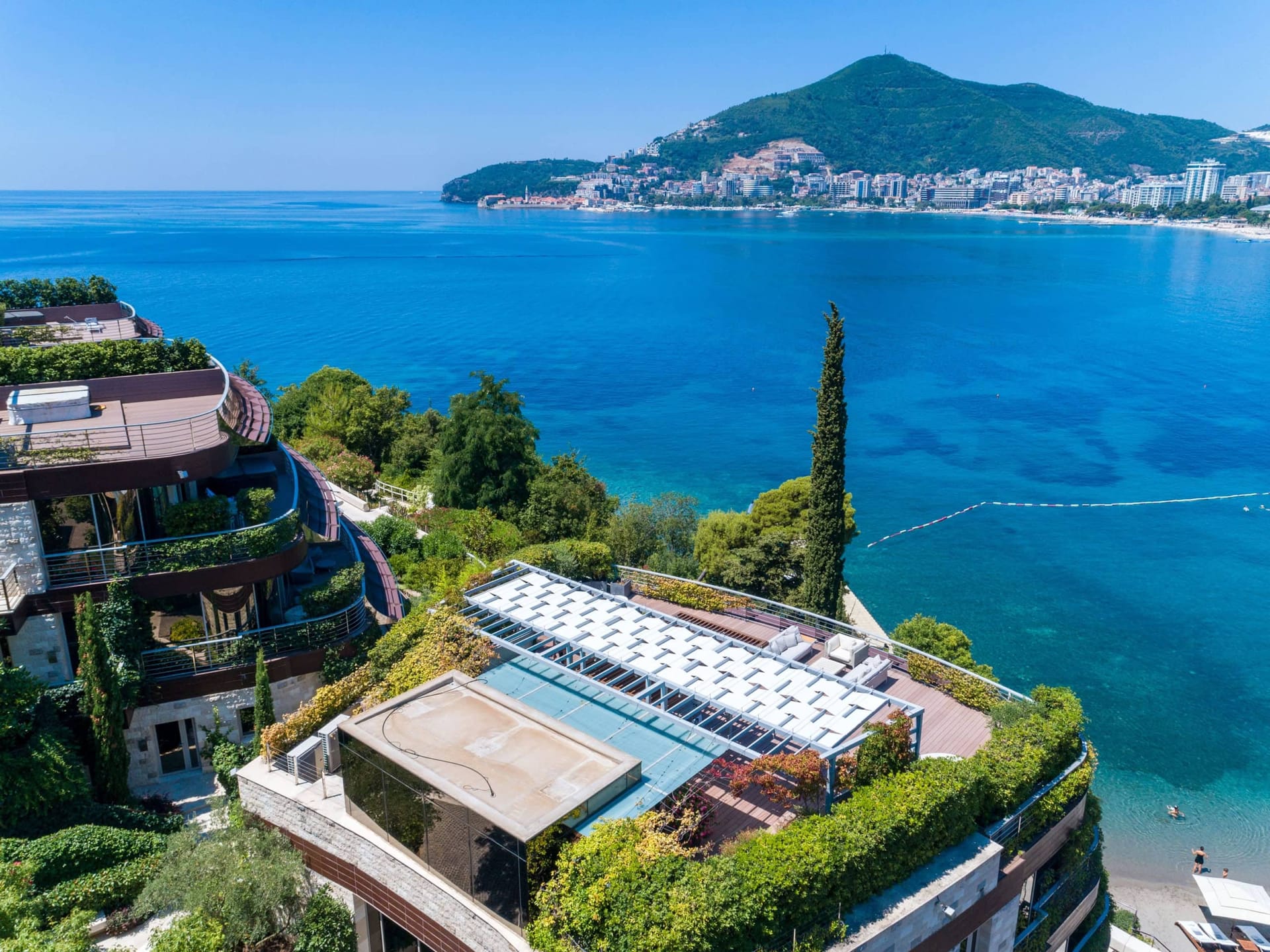 Luxury residential complex in Budva, Montenegro: view from the terrace of the sea, modern architecture, and landscape design.