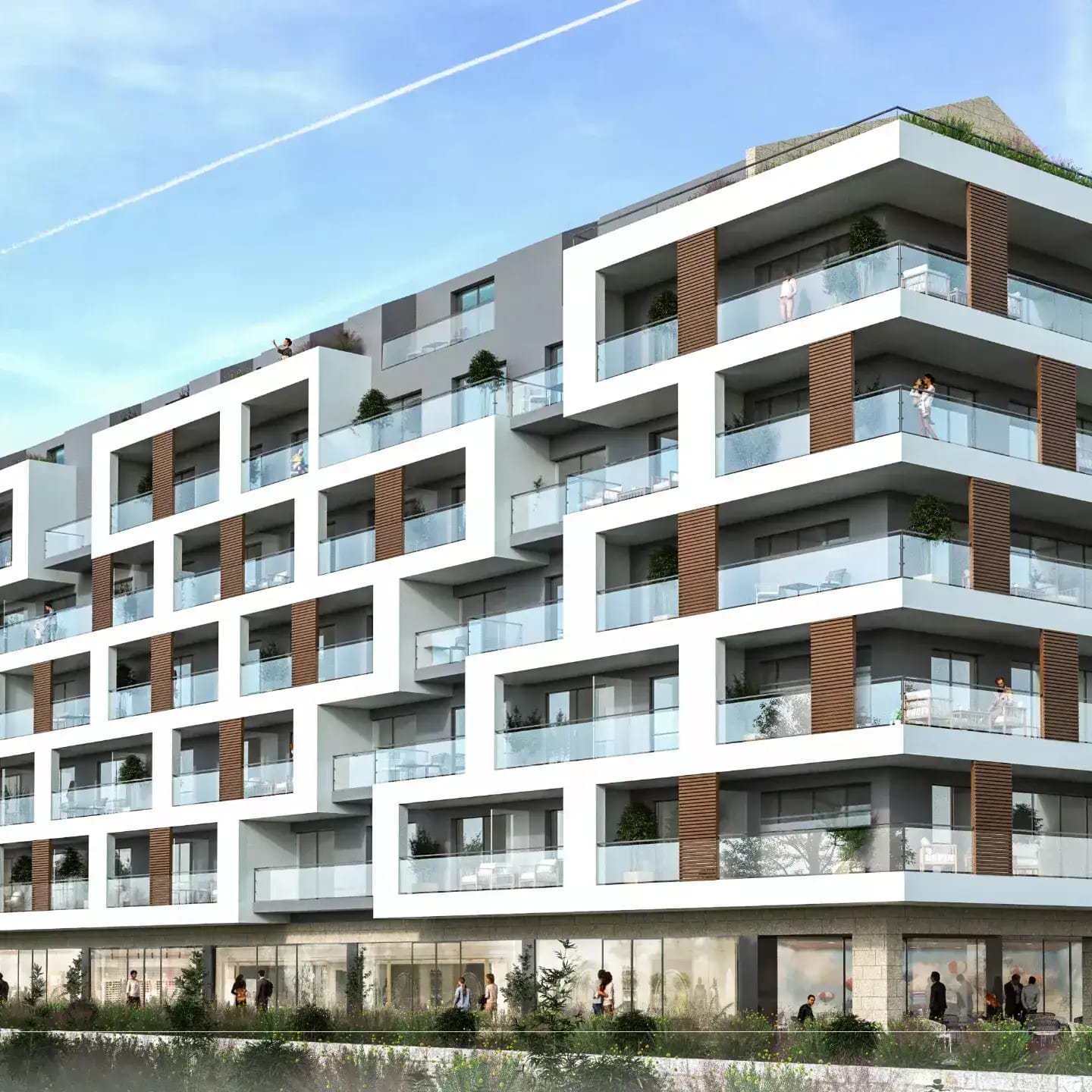 Modern residential complex in Budva, Montenegro: facade with terraces, panoramic glazing, and a commercial floor.