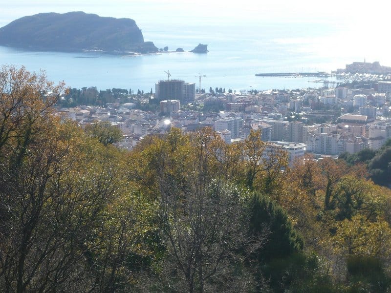 Panoramic view of Budva and St. Nicholas Island, land plot in Montenegro with sea and mountain views.