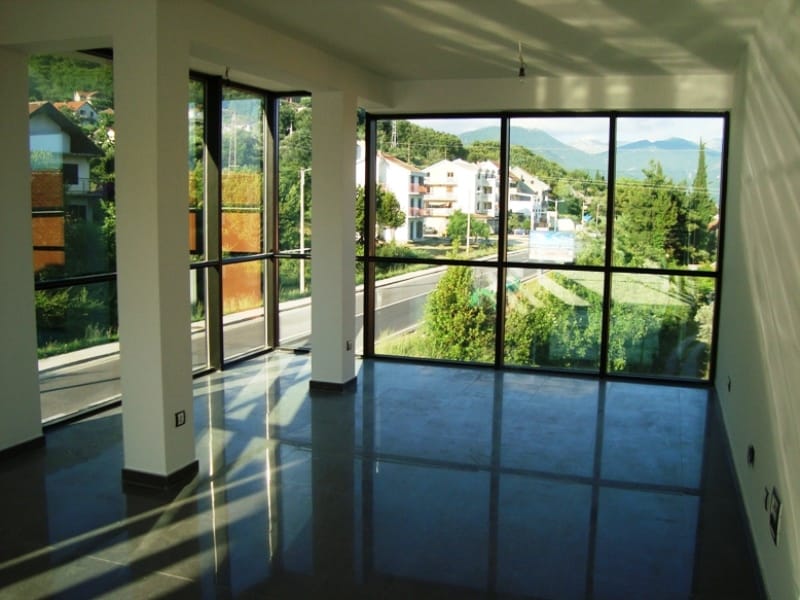 Gewerbefläche in Baošići, Montenegro: helles Wohnzimmer mit Panoramafenstern und Blick auf die Berge und die Straße.