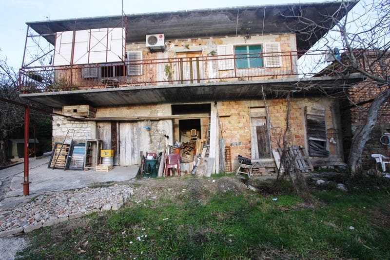 Dvospratna kuća za rekonstrukciju sa terasom i fasadom od cigle u Kalarovu, Krašići, Crna Gora.