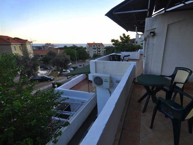Spacious balcony with furniture and sea view in a house in Petrovac, Montenegro. Tiled floor, air conditioning, summer area.