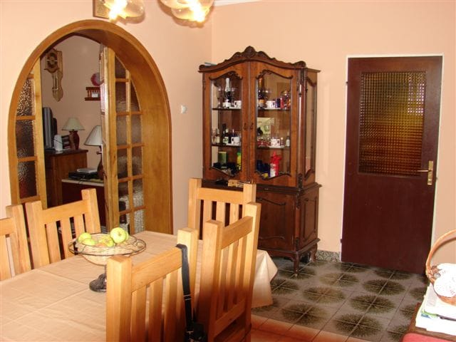 Living room interior with wooden furniture and an arched passage in a house for sale in Budva, Montenegro.