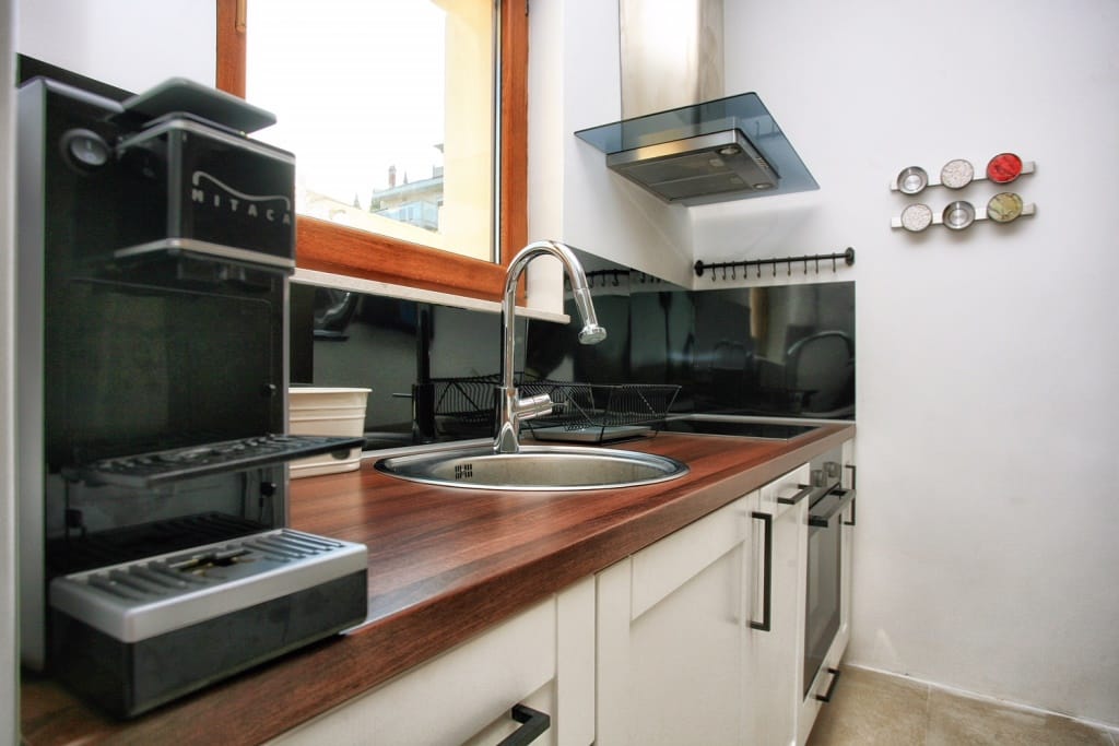 Modern kitchen with a wooden countertop and appliances in a villa in Herceg Novi, Montenegro.