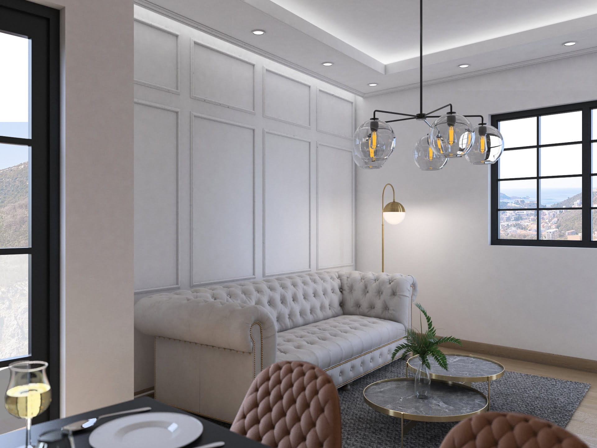Helles Wohnzimmer mit Chesterfield-Sofa in der Wohnanlage Bečići, Budva-Riviera, Montenegro: Meer- und Bergblick aus dem Fenster.