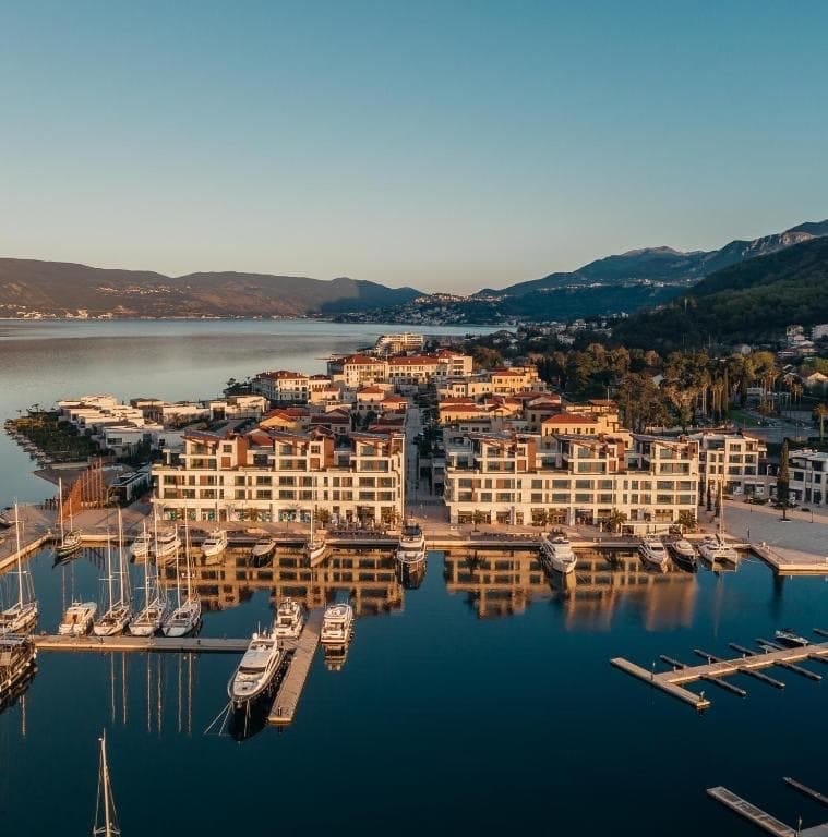 Aerial view of the luxury Portonovi residential complex in Kumbor, Montenegro, with modern architecture and a yacht marina.