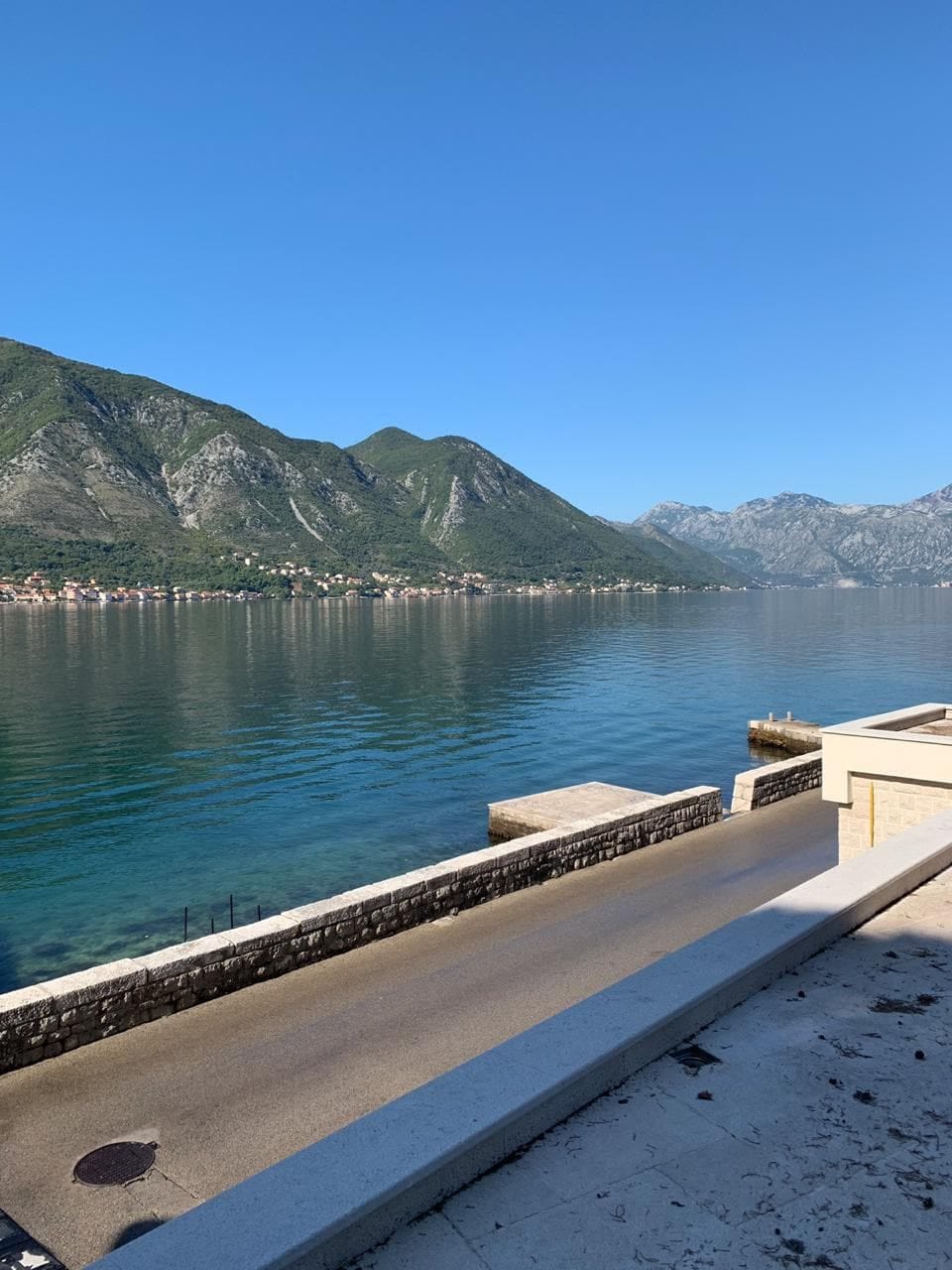 Panoramic view of the Bay of Kotor and the mountains from the villa terrace in Dobrota, Montenegro. Seafront promenade.