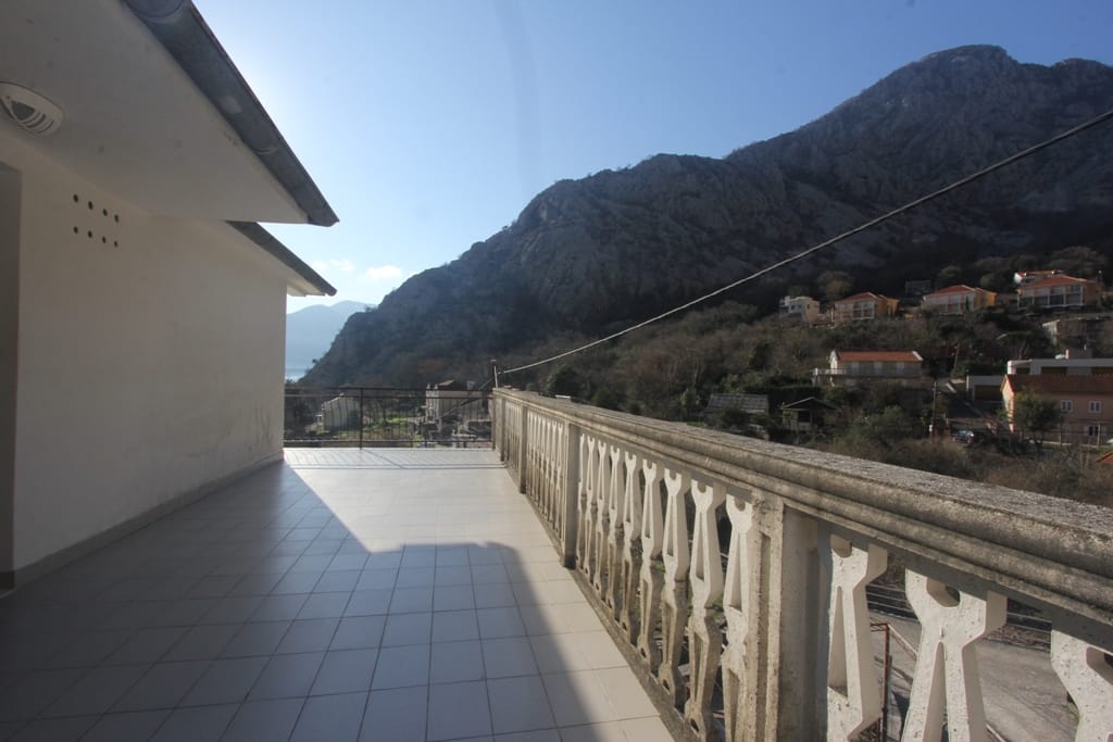 Spacious terrace with tiled floor and mountain views in a house in Orahovac, Montenegro.