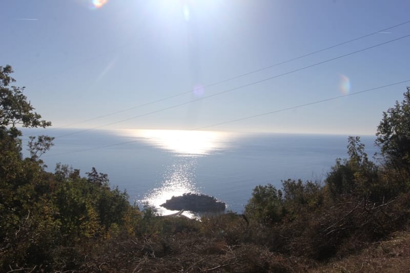Panoramic view of the island of Sveti Stefan and the Adriatic Sea from a land plot in Montenegro, Budva Riviera.