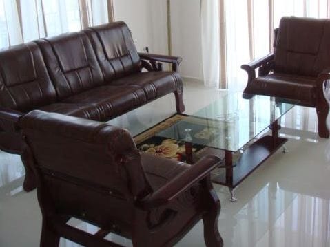 Wohnzimmer mit Ledermöbeln und Glastisch in einer Wohnung in Stoliv, Montenegro: helles Interieur mit Panoramafenstern.