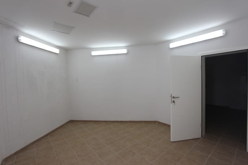 Bright commercial space for an office or restaurant in Sveti Stefan, Montenegro, with white walls and tile.