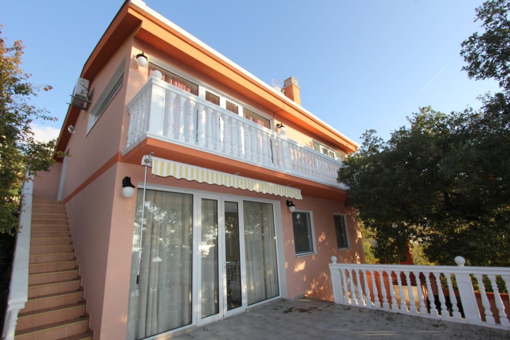 Two-story house with a terrace and balcony in Ratac, Bar Riviera, Montenegro: facade with stairs and panoramic windows.