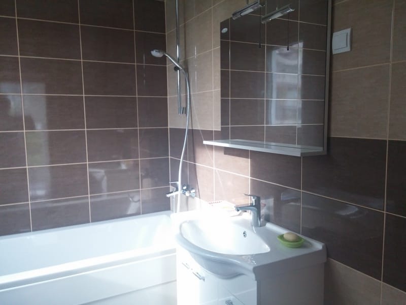 Modern bathroom with a shower and tiled walls in a house in Đenovići, Montenegro. Bathroom interior with new fixtures.